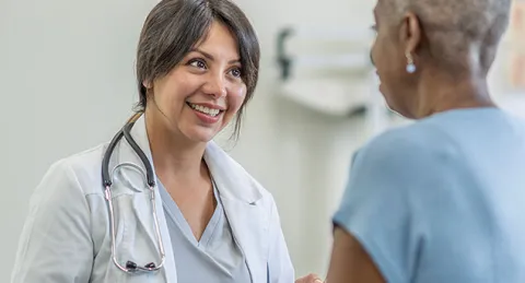 Nurse practitioner in adult-gerontology acute care with patient
